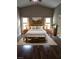 Staged primary bedroom boasts high ceilings, hardwood floors, and a decorative rug at 1382 Fountain Lakes Drive Dr, Lawrenceville, GA 30043
