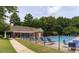 Community pool featuring an outdoor seating area, and surrounded by green trees and well-manicured landscaping at 1382 Fountain Lakes Drive Dr, Lawrenceville, GA 30043