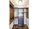 Walk-in closet features custom shelving, hardwood floors, and ample storage at 1382 Fountain Lakes Drive Dr, Lawrenceville, GA 30043