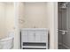 Neat bathroom showcasing a vanity with white marble countertop and a walk-in closet with shelving at 3210 Quincetree Lane Ln, Decatur, GA 30034