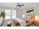 Modern bedroom featuring a ceiling fan, large windows, and stylish neutral decor with natural wood furniture at 3210 Quincetree Lane Ln, Decatur, GA 30034
