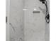 Elegant marble-tiled shower featuring a modern showerhead, a convenient inset shelf, and a sleek design at 3210 Quincetree Lane Ln, Decatur, GA 30034