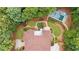 Aerial view showing a home with mature trees, a pool, and lush landscaping in a private backyard oasis at 10630 N Edgewater Pl, Johns Creek, GA 30097