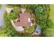 Stunning aerial view of the home, showcasing the lush landscaping, circular drive, and private pool area at 10630 N Edgewater Pl, Johns Creek, GA 30097