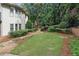 Picturesque backyard featuring lush grass, stepping stones, and garden beds at 10630 N Edgewater Pl, Johns Creek, GA 30097