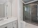 Modern bathroom featuring a glass-enclosed shower, marble floors, and sleek fixtures at 10630 N Edgewater Pl, Johns Creek, GA 30097