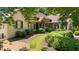 Spacious home with a side entry garage and meticulously landscaped yard with mature trees at 10630 N Edgewater Pl, Johns Creek, GA 30097