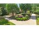 Stately home with a circular driveway, mature trees, and verdant landscaping at 10630 N Edgewater Pl, Johns Creek, GA 30097