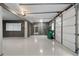 Spacious garage with epoxy flooring offers ample room for parking and storage, complemented by natural light at 10630 N Edgewater Pl, Johns Creek, GA 30097