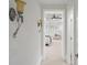 Hallway leading to the main bedroom, featuring decorative sconces and a view of the bay window at 10630 N Edgewater Pl, Johns Creek, GA 30097