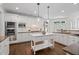 Bright kitchen featuring white cabinets, a center island, stainless steel appliances, and hardwood flooring at 10630 N Edgewater Pl, Johns Creek, GA 30097