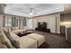 Comfortable living room featuring recessed lighting, plush sectional sofa, and sleek entertainment center at 10630 N Edgewater Pl, Johns Creek, GA 30097