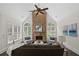 Cozy living room featuring a stone fireplace and large windows with natural light at 10630 N Edgewater Pl, Johns Creek, GA 30097