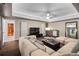 Spacious living room with a plush sectional sofa, wet bar, and modern decor at 10630 N Edgewater Pl, Johns Creek, GA 30097