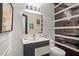 Stylish powder room with textured walls, modern lighting, and elegant black and white accents at 10630 N Edgewater Pl, Johns Creek, GA 30097