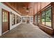 Spacious sunroom features stone flooring, wood ceiling, and large windows for natural light at 10630 N Edgewater Pl, Johns Creek, GA 30097