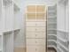 Walk-in closet with custom shelving, drawers, and ample storage space for organization at 10630 N Edgewater Pl, Johns Creek, GA 30097