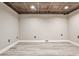 Unfinished basement with decorative tiled ceiling and light vinyl flooring at 2786 Overlook Ne Dr, Atlanta, GA 30345