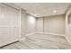 Finished basement with wood flooring, neutral walls, and a storage area behind louvered doors at 2786 Overlook Ne Dr, Atlanta, GA 30345