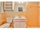 Bathroom with yellow tiling, vintage-style vanity and sink, and neutral colored fixtures at 2786 Overlook Ne Dr, Atlanta, GA 30345