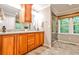 Bathroom featuring double vanity, stone countertops, framed mirrors, and a glass enclosed shower at 2786 Overlook Ne Dr, Atlanta, GA 30345
