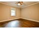 Bedroom featuring hardwood floors, a ceiling fan, a window, and neutral-colored walls at 2786 Overlook Ne Dr, Atlanta, GA 30345