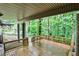 Covered deck with string lights and views of the surrounding greenery offers a perfect spot for outdoor relaxation at 2786 Overlook Ne Dr, Atlanta, GA 30345