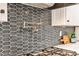 Close up of a gourmet kitchen featuring custom tile backsplash and stainless steel pot filler over a gas range at 2786 Overlook Ne Dr, Atlanta, GA 30345