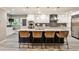 Modern kitchen with white cabinetry, stainless steel appliances, large island with seating and statement lighting at 2786 Overlook Ne Dr, Atlanta, GA 30345