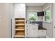 Wet bar featuring white cabinetry, beverage refrigerator, sink and additional storage at 2786 Overlook Ne Dr, Atlanta, GA 30345