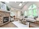 Cozy living room with stone fireplace, vaulted ceiling, large windows, and modern furnishings at 2786 Overlook Ne Dr, Atlanta, GA 30345