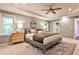 Comfortable main bedroom featuring a tray ceiling, ceiling fan, neutral tones, and a king bed at 2786 Overlook Ne Dr, Atlanta, GA 30345