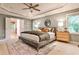 A spacious main bedroom featuring a tray ceiling, neutral decor, and plush carpeting at 2786 Overlook Ne Dr, Atlanta, GA 30345