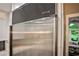 Stainless steel Sub-Zero refrigerator with custom cabinetry and a view into a living space beyond at 2786 Overlook Ne Dr, Atlanta, GA 30345