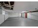 Unfinished basement with three garage doors and painted block walls at 4191 Alaina Cir, Austell, GA 30106