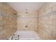 Bathroom features a soaker tub and tiled walls with decorative glass tile border at 4191 Alaina Cir, Austell, GA 30106