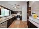 Well-lit kitchen featuring dark cabinetry, stainless steel appliances, granite countertops, and modern fixtures at 4191 Alaina Cir, Austell, GA 30106