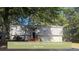 Charming home with a well-maintained exterior and a lush, tree-filled front yard at 4191 Alaina Circle Cir, Austell, GA 30106