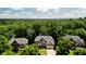 Aerial view of a brick home nestled amongst trees at 5059 Belair Bluff Se Ct, Smyrna, GA 30126