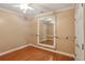 Spare bedroom with light hardwood floors and wall mirror at 5059 Belair Bluff Se Ct, Smyrna, GA 30126
