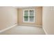 Neutral bedroom featuring carpeted floor, white trim, and large window at 5059 Belair Bluff Se Ct, Smyrna, GA 30126