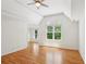 Bright bedroom features hardwood floors, vaulted ceilings, and a large window for ample natural light at 5059 Belair Bluff Se Ct, Smyrna, GA 30126
