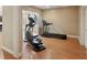Home gym with exercise bike and treadmill on light hardwood flooring at 5059 Belair Bluff Se Ct, Smyrna, GA 30126