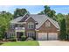 Charming brick home with a manicured lawn, mature trees, and an attached two-car garage at 5059 Belair Bluff Se Ct, Smyrna, GA 30126