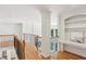 Upstairs hallway with wood floors and built in shelves at 5059 Belair Bluff Se Ct, Smyrna, GA 30126