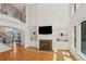 Open-concept living room with a fireplace, built-in shelving, and a staircase with iron railings at 5059 Belair Bluff Se Ct, Smyrna, GA 30126