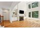Spacious living room with hardwood floors, a fireplace, and built-in shelving at 5059 Belair Bluff Se Ct, Smyrna, GA 30126