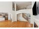Spacious living room with hardwood floors, fireplace, and staircase with decorative iron spindles at 5059 Belair Bluff Se Ct, Smyrna, GA 30126