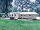 A serene backyard with a well-maintained lawn, deck, and outdoor seating is perfect for outdoor gatherings at 543 S Holly Springs Rd, Woodstock, GA 30188