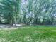 Lush backyard features mature trees and a playset at 543 S Holly Springs Rd, Woodstock, GA 30188